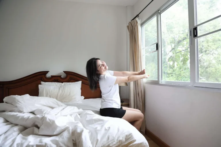 woman stretching in bed