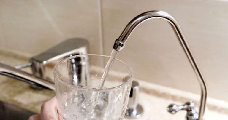 glass of water being filled from faucet