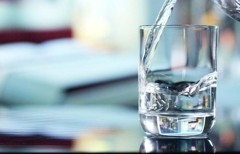 water pouring into a clear glass