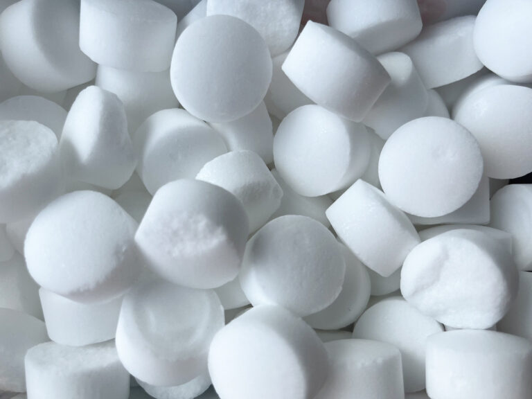 Background of tableted salt for softening water close-up.